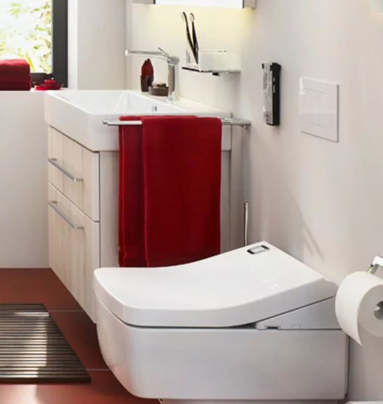 Badezimmer mit WC, Waschbecken, Dusche und Heizkörper